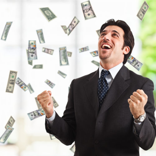 Happy man enjoying the rain of money